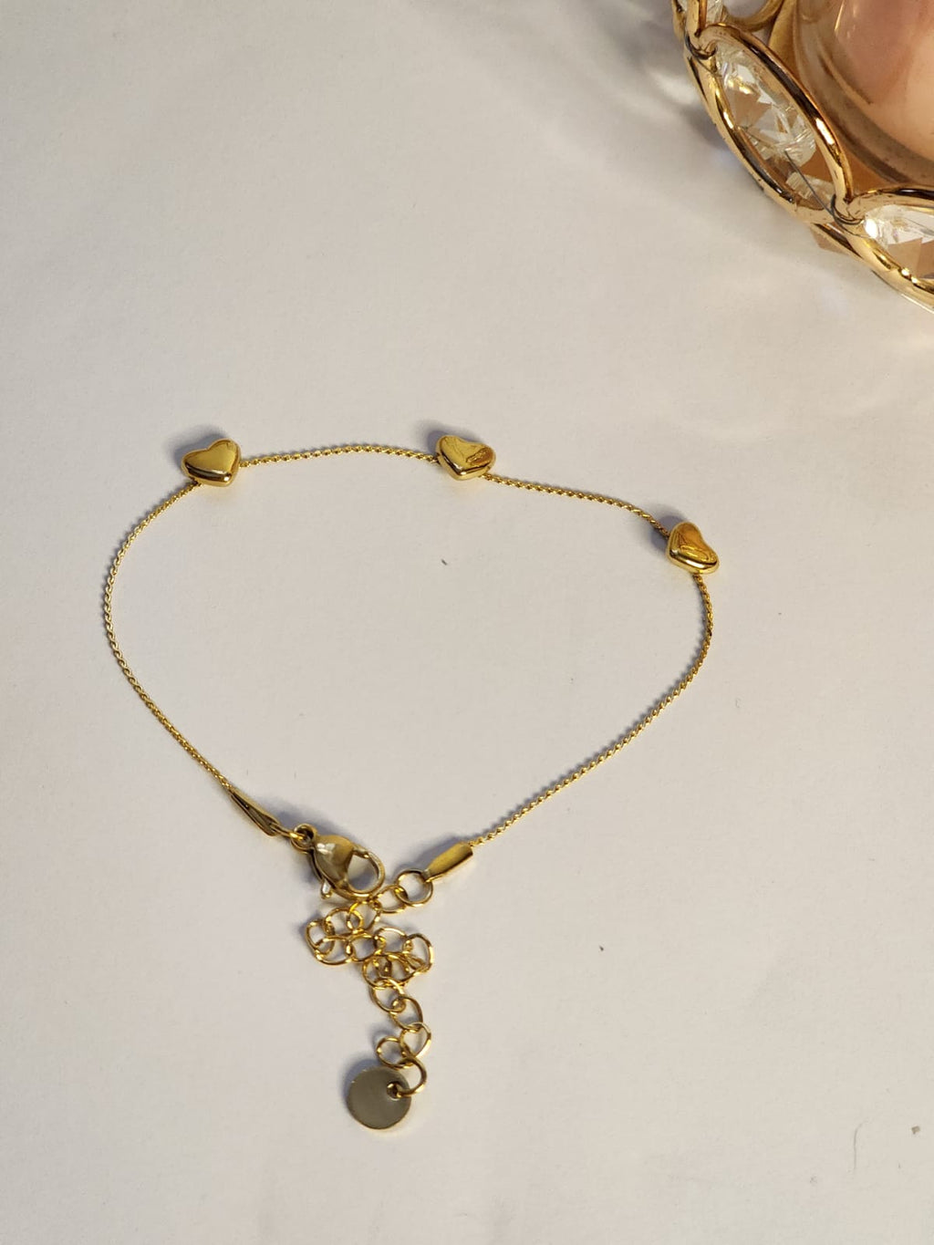 Triple heart station gold chain bracelet showing full bracelet with lobster clasp