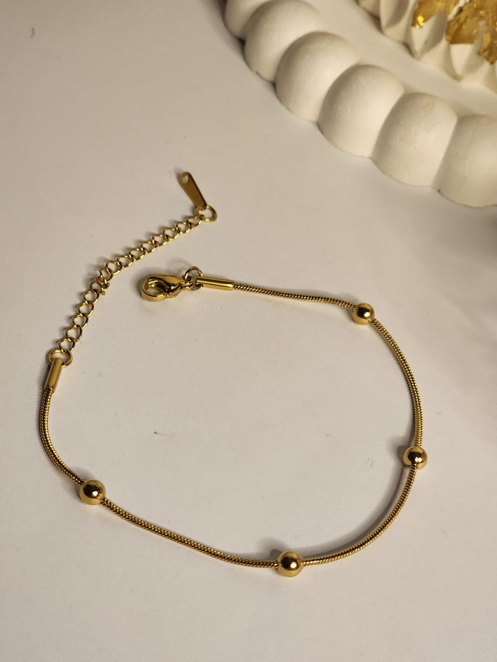 Gold snake chain ball station bracelet full view with lobster clasp