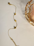 Triple heart station gold chain bracelet laid flat showing extender chain