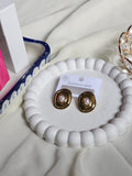 Gold chunky square pearl centre stud earrings front view on white display tray