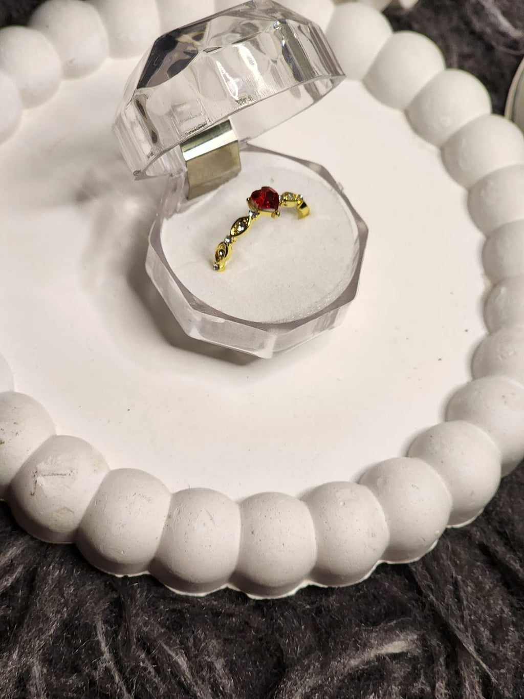 Red heart CZ gold ring in crystal box - top view