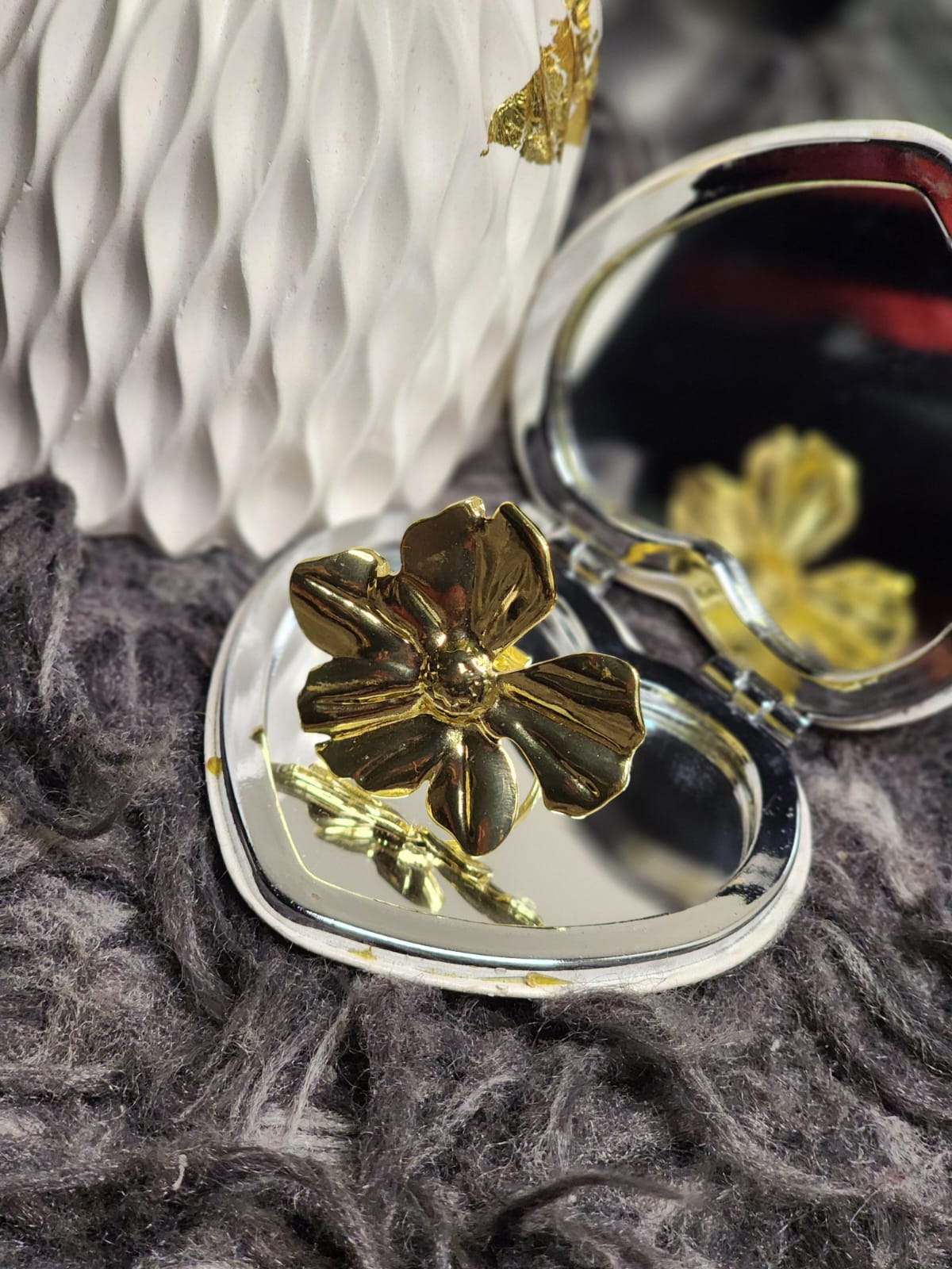 Gold Sculpted Bloom Ring — resting in open heart-shaped compact mirror