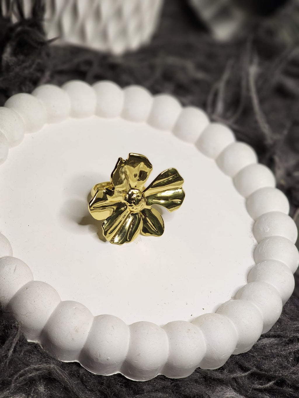 Gold Sculpted Bloom Ring — top view on white display tray