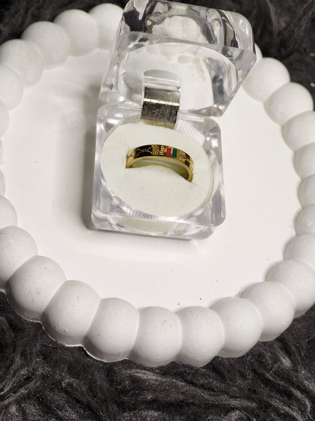 Gold solitaire and pave band ring set close up in acrylic gift box