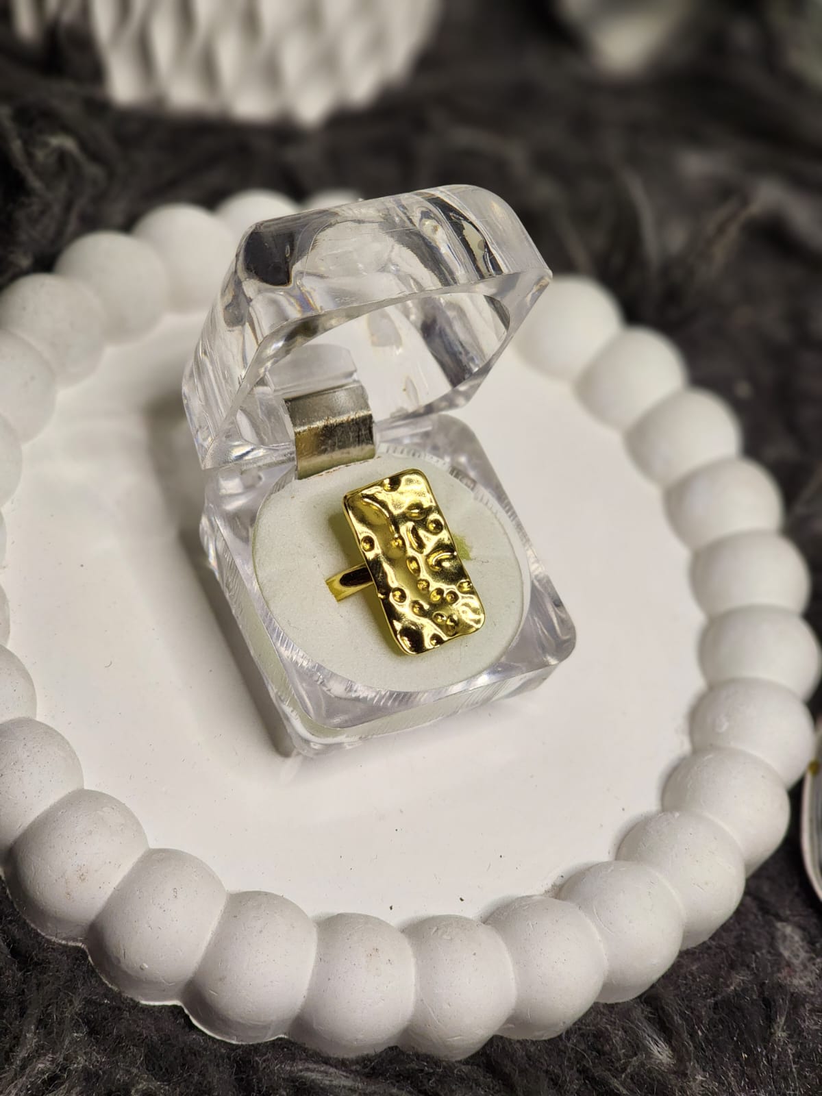 Gold stripe band ring close up in acrylic gift box