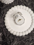 Black flower gold ring in clear acrylic gift box on white scalloped tray