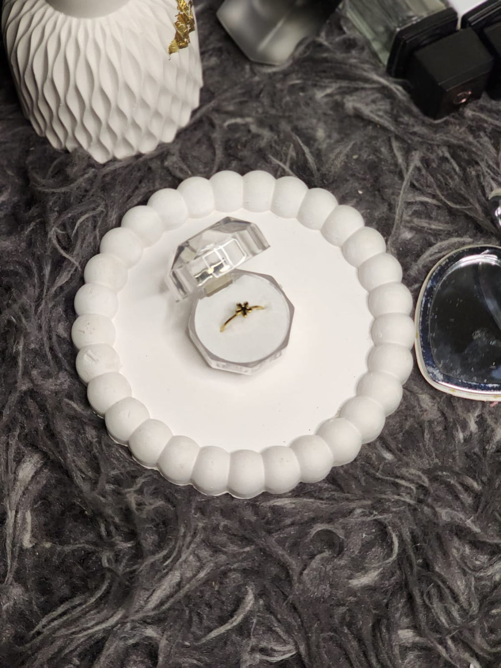 Black flower gold ring in gift box with styling props