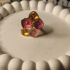 Gold finish floral statement ring with handcrafted pink and yellow petals and crystal centers.